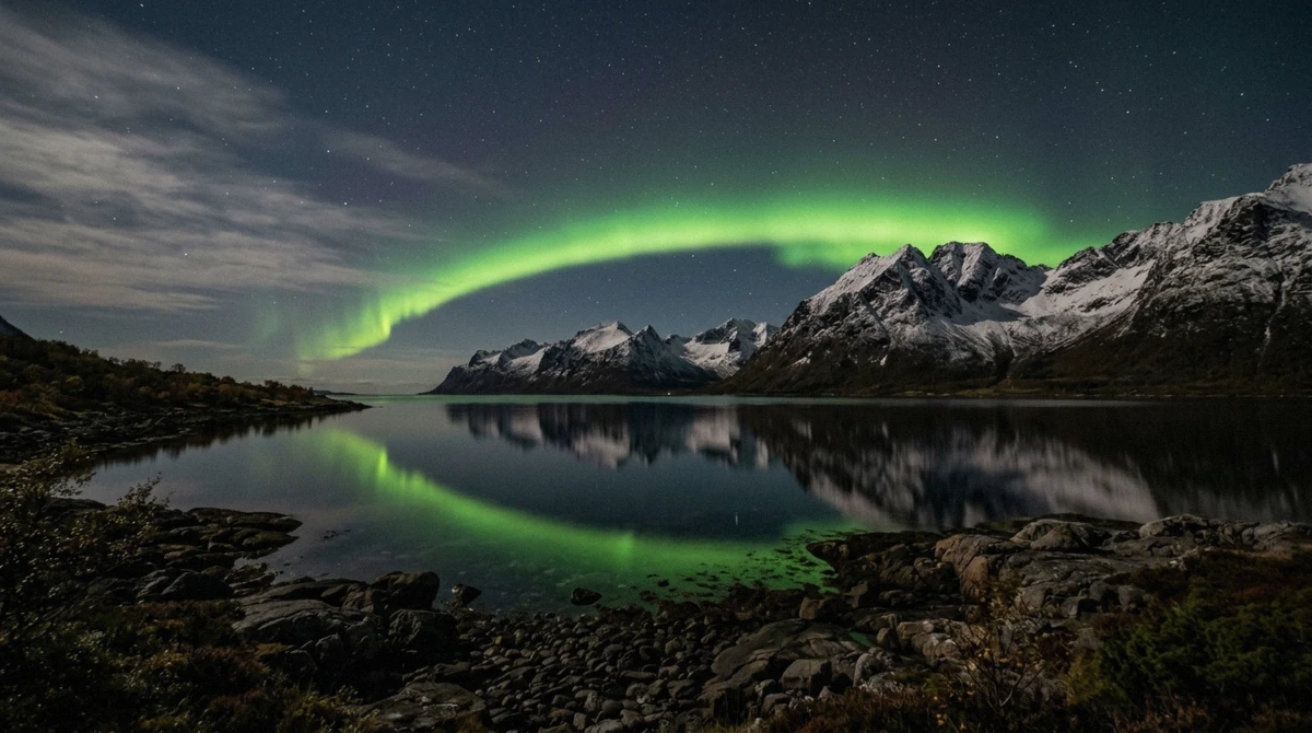 Aurora light over a dark fjord near Tromsø, one of the free spots to see the northern lights in Tromsø without a tour